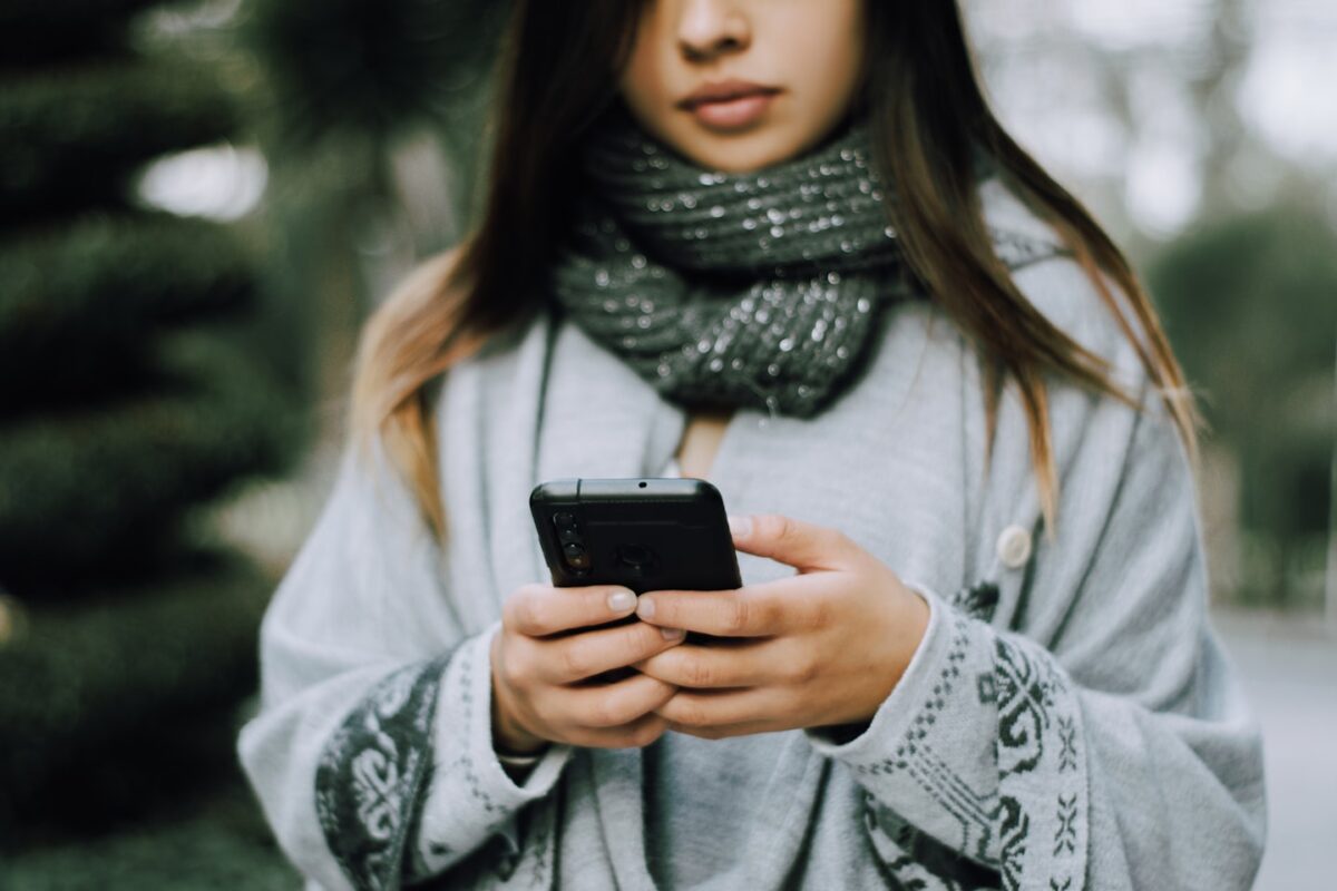 Young woman checking follow-up emails on a smartphone after a fitness trial